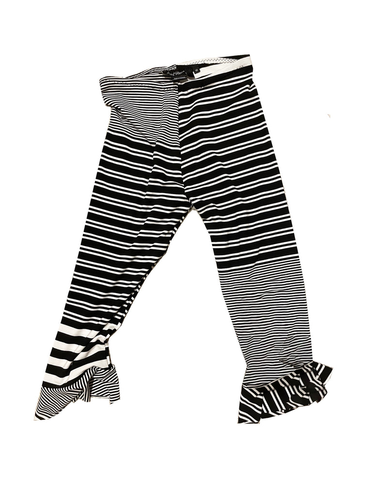 Black and white striped pants with ruffled bottom on a white background