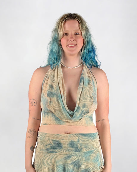 Woman wearing a blue and beige top and skirt set on a white background