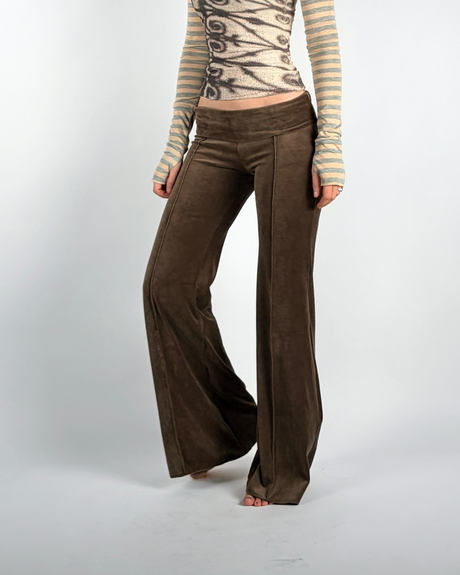 Brown japanese velour pants worn by a person on a white background