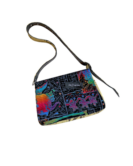 Colorful patterned handbag with a strap on a white background