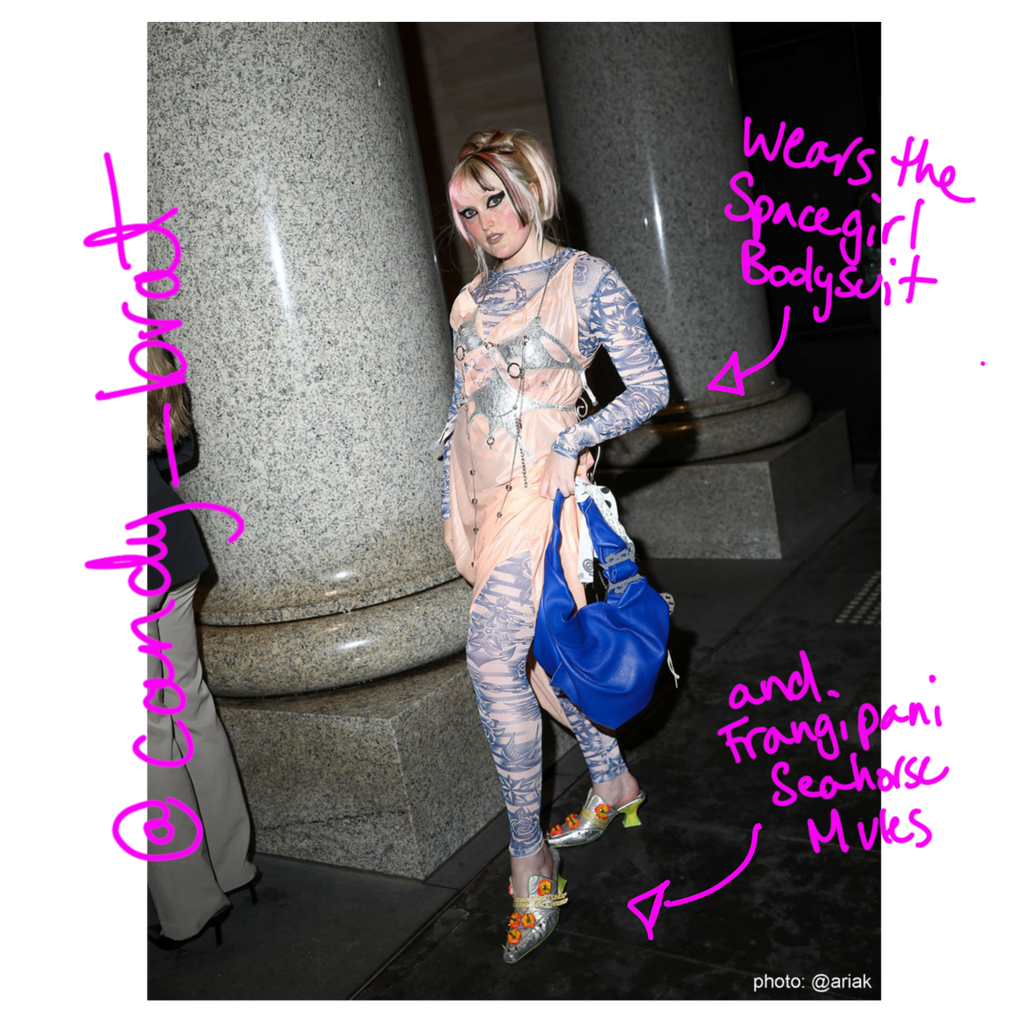 Person on the street in a unique outfit with pink text annotations pointing to specific items. one reads "@candy_brat", another reads "wears the spacegirl bodysuit", another reads "and frangipani seahorse mules"