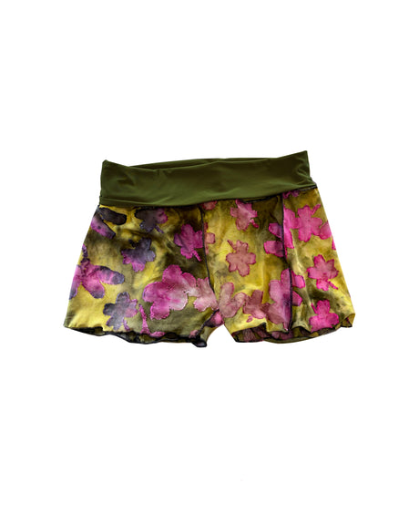 Floral shorts with a green waistband on a white background