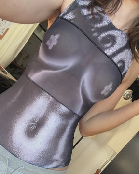 person wearing mesh tank top with print of torso on it
