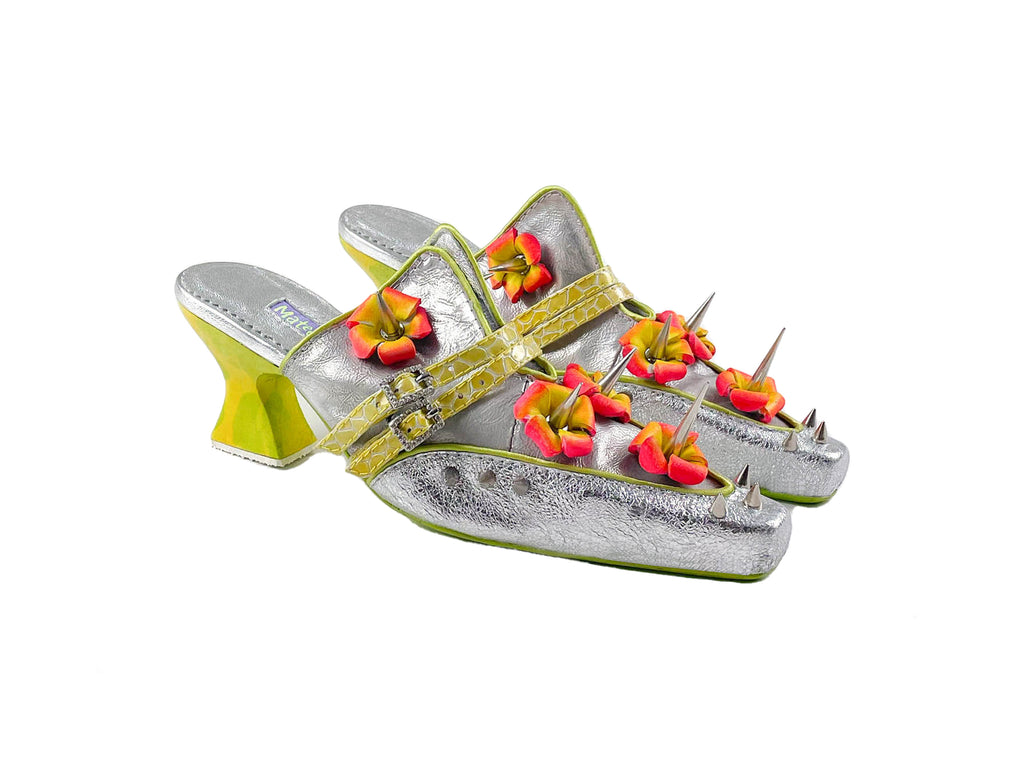 silver low heeled shoes featuring silver spikes and leather red and orange flowers on a white backround