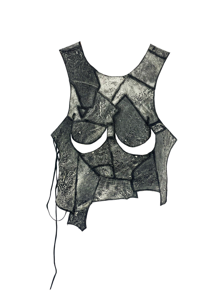 unique leather patchwork sleeveless lace up top made from salvaged leathers with under breast boob cut-outs on a plain background