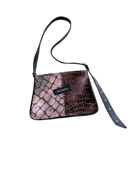 Snake pattern handbag with a strap on a white background