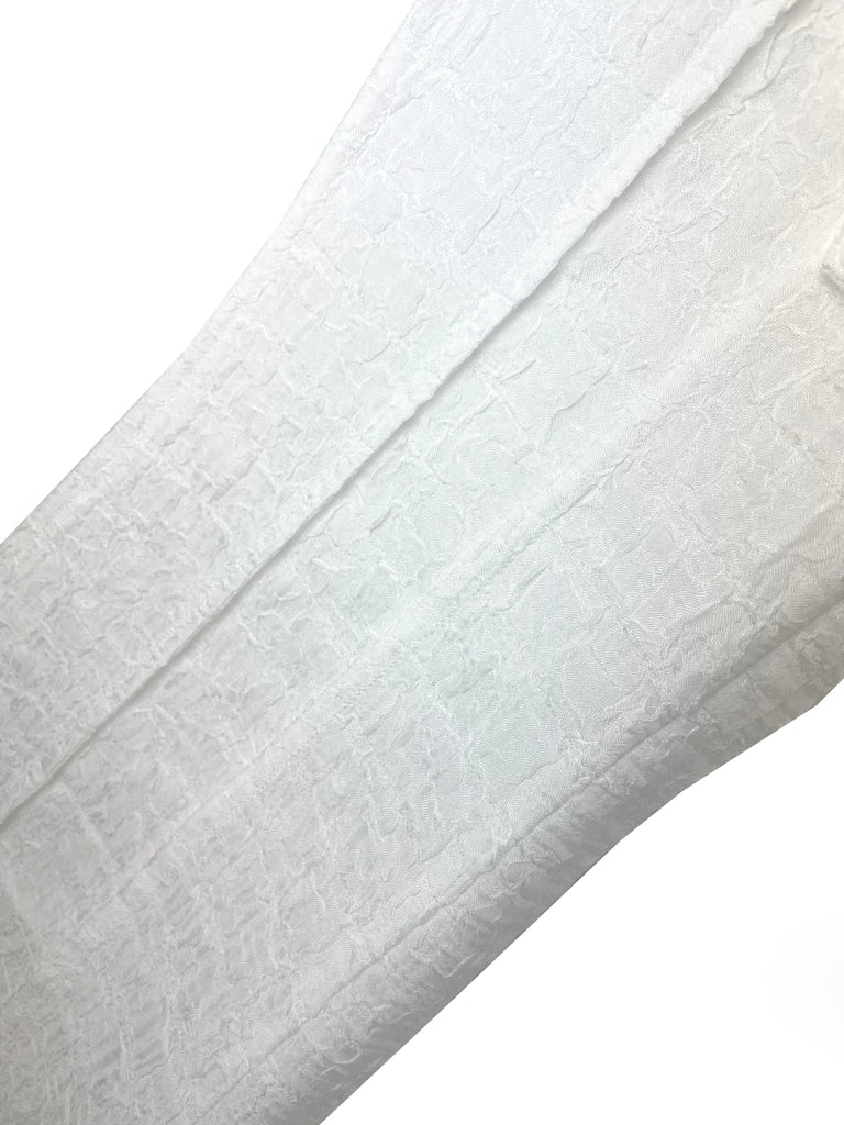 Close-up of a white textured fabric on a white background
