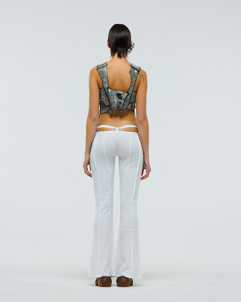 Model wearing white pants with suspended drawstring and vertical french seams with grey tank top on a plain background