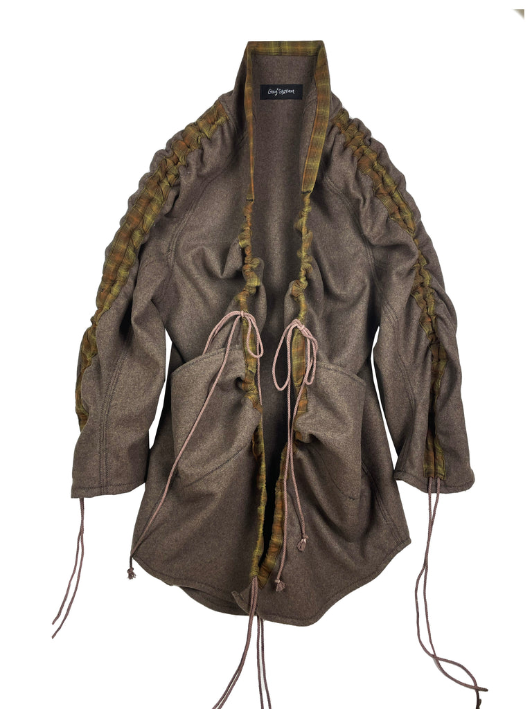 Brown wool jacket coat with gathered drawstring sleeves and front, and large pockets on a white background